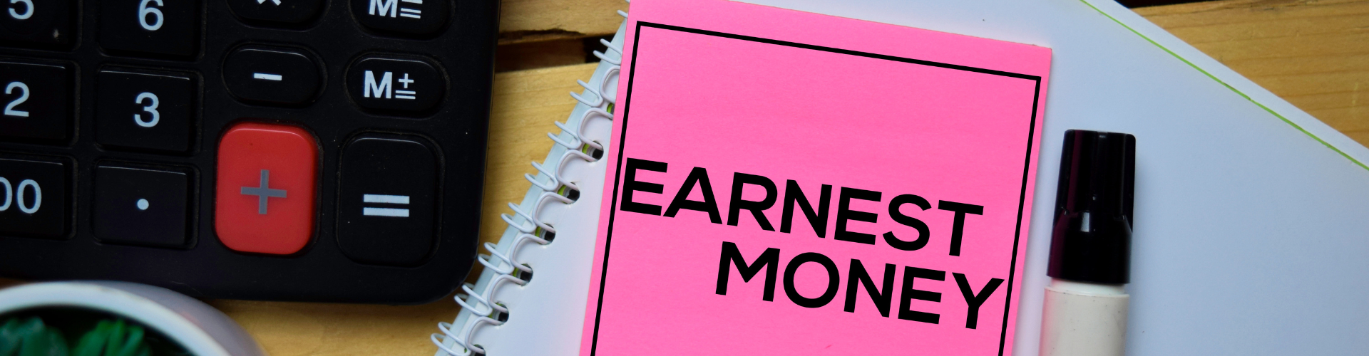 A pink notepad next to a keyboard and a remote control.