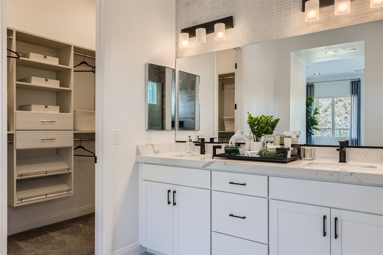 A bathroom with white cabinets.