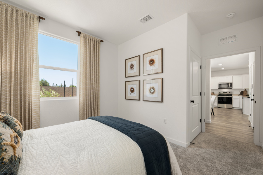 A bedroom with a bed and a window.