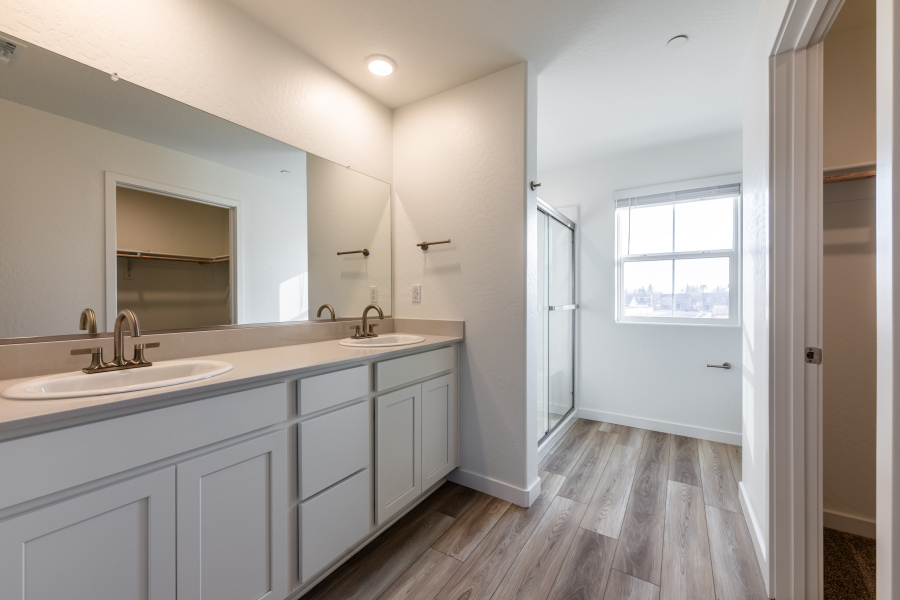A bathroom with white cabinets.