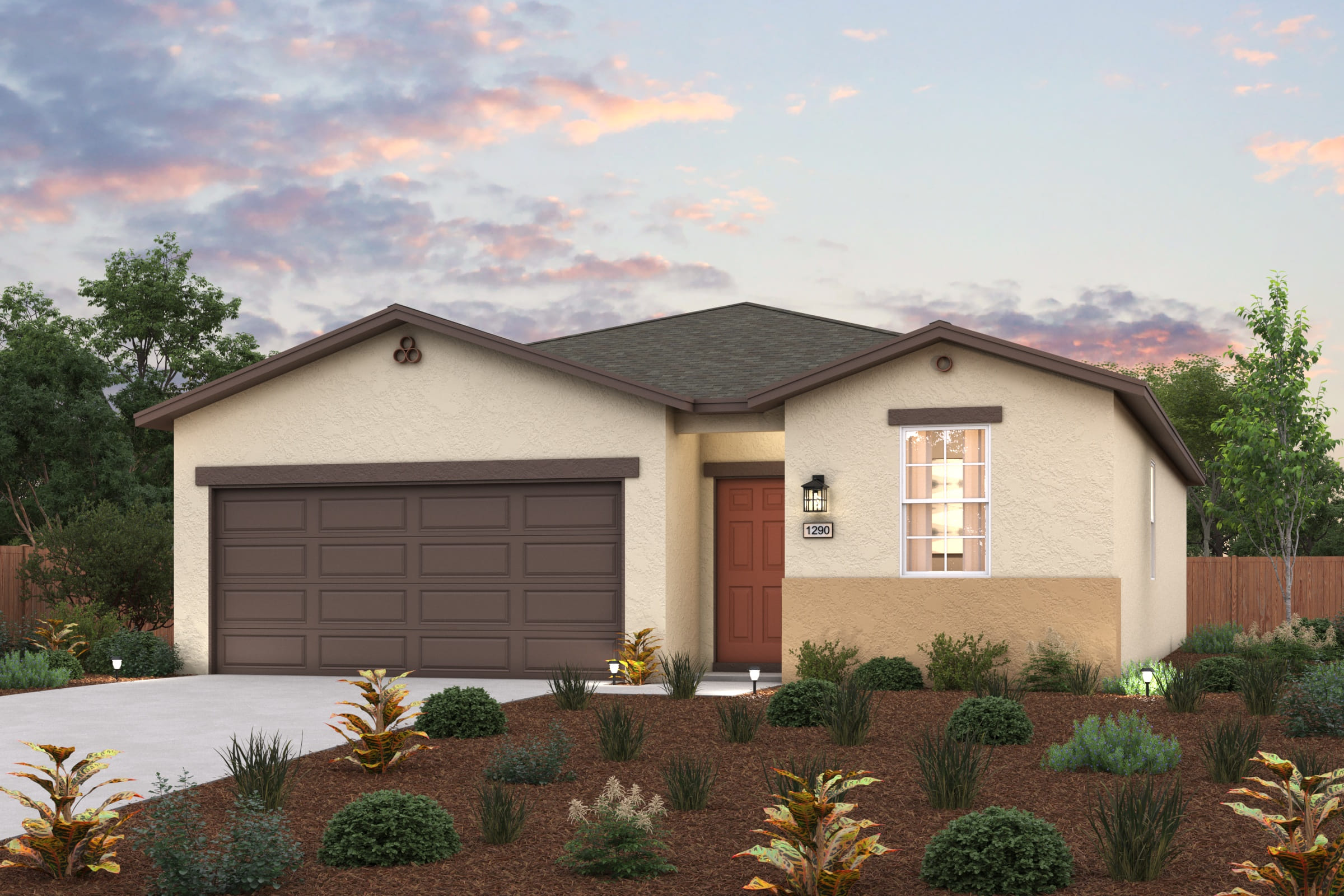 A house with a garage and bushes in front of it.