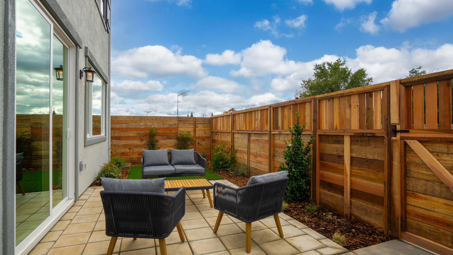 A deck with chairs and a table.