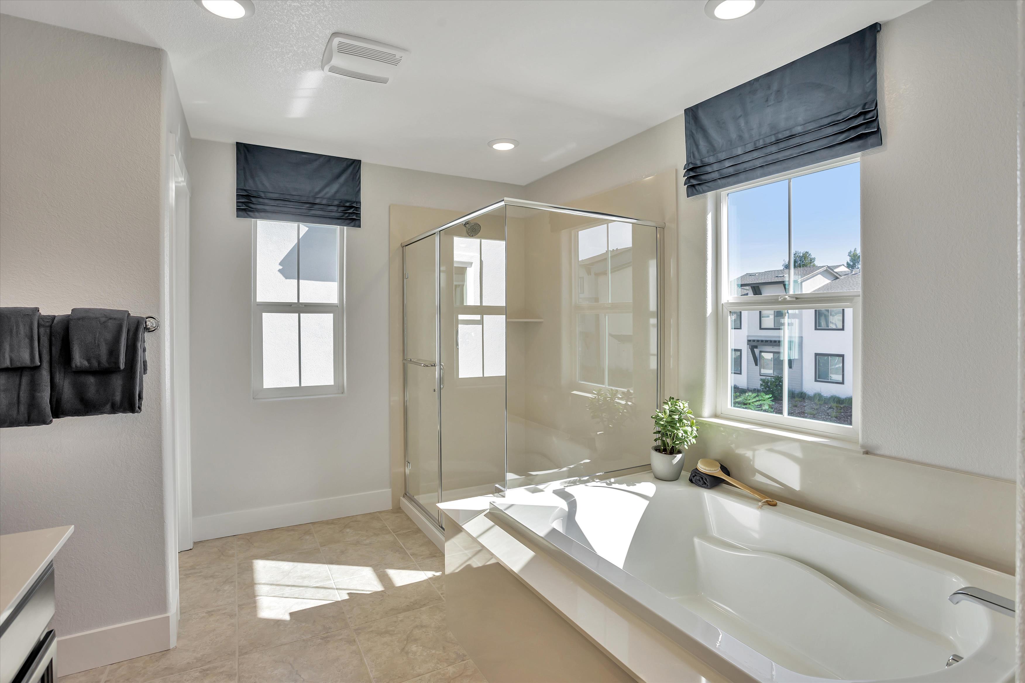 A bathroom with a tub and shower.