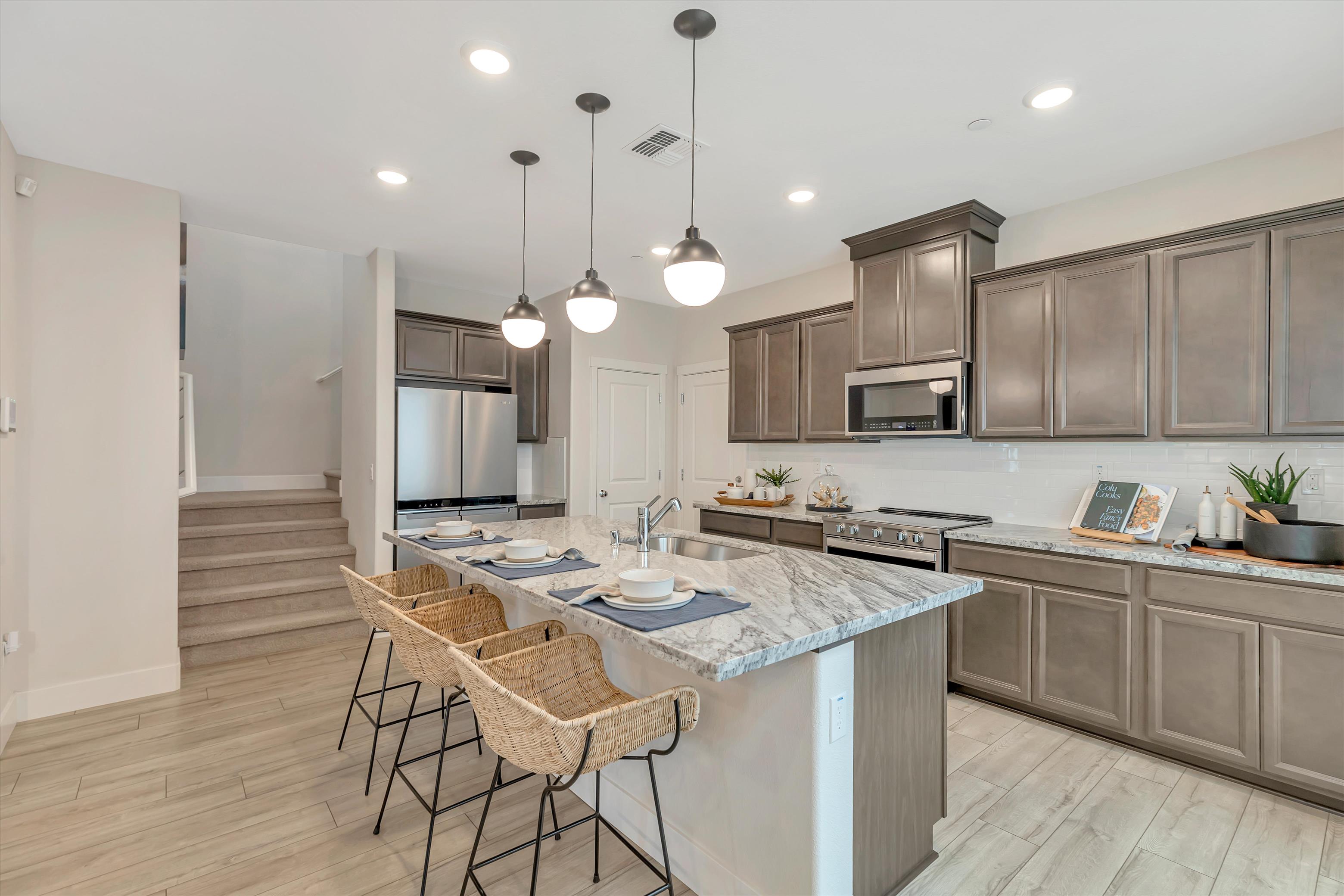 A kitchen with a island and a table.