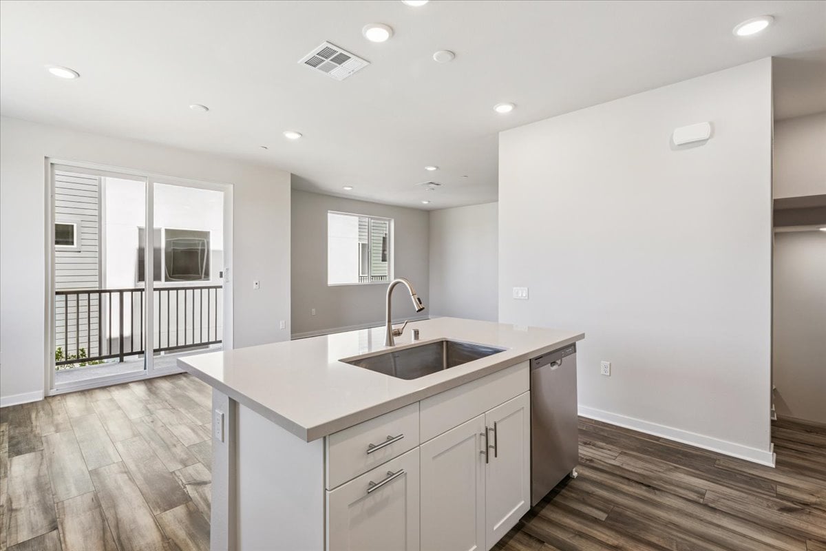 A kitchen with white cabinets.