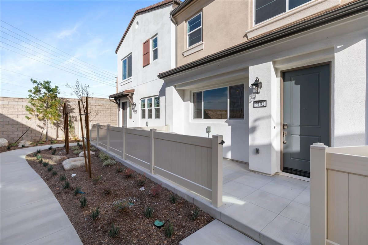 A white building with a fence.