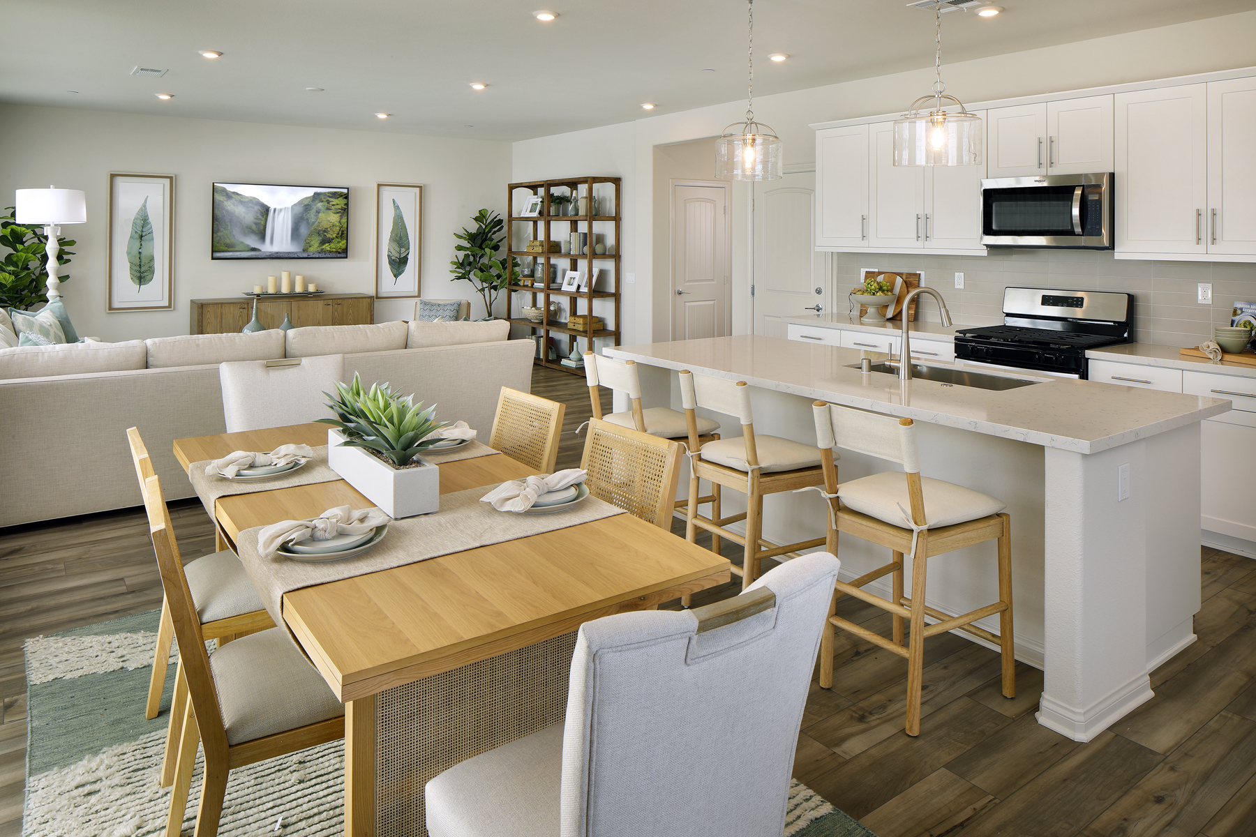 A kitchen with a dining table and chairs.