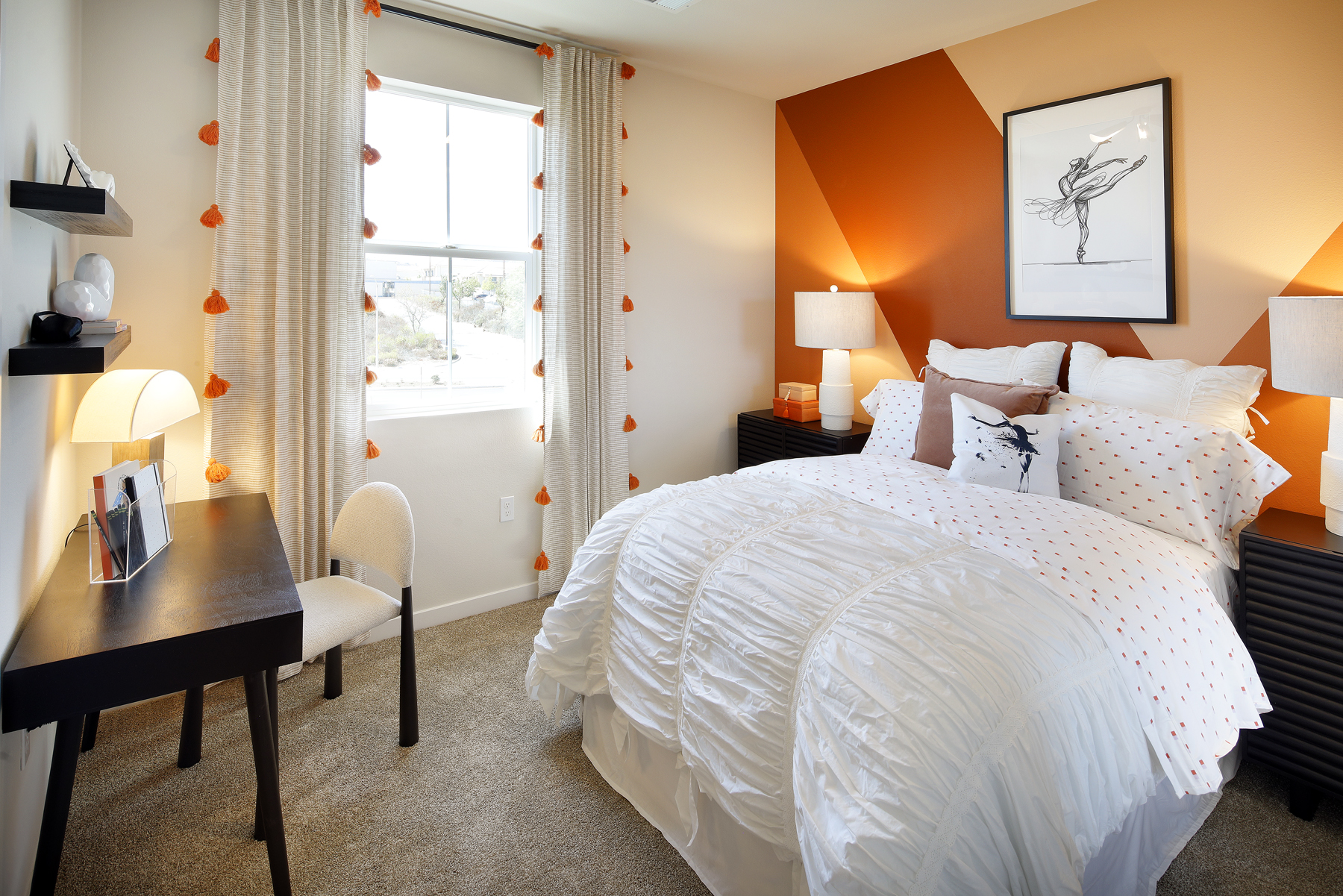 A bedroom with a bed and a desk.