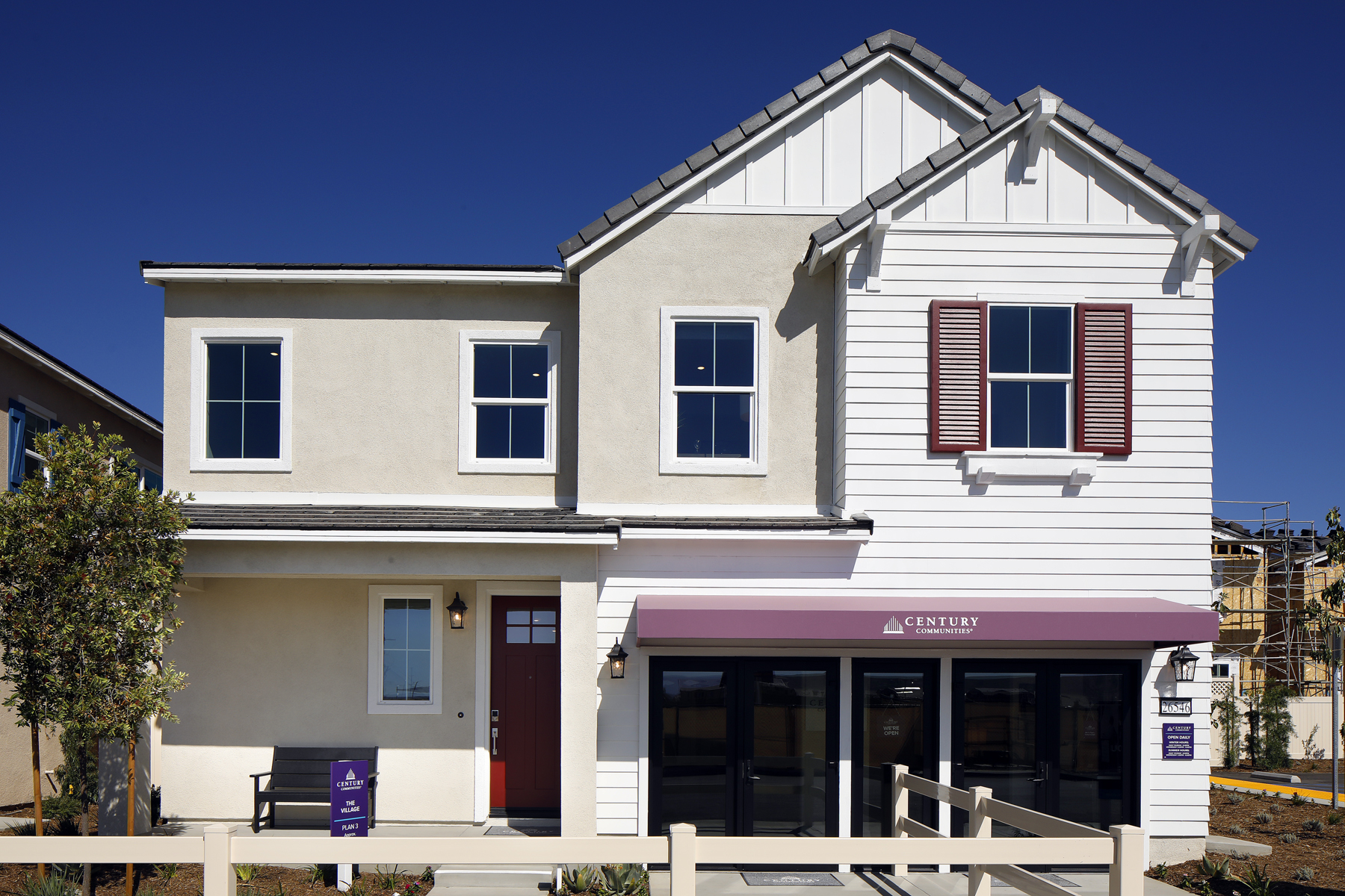 A white building with red shutters.