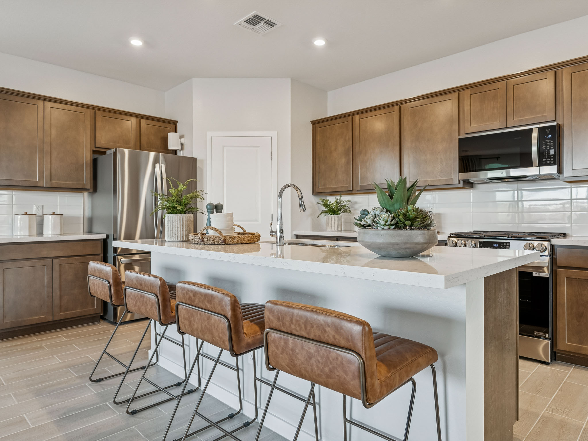 A kitchen with a marble island.