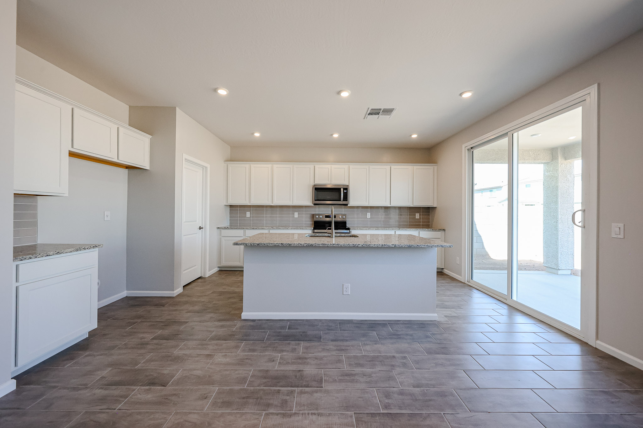 A kitchen with white cabinets.