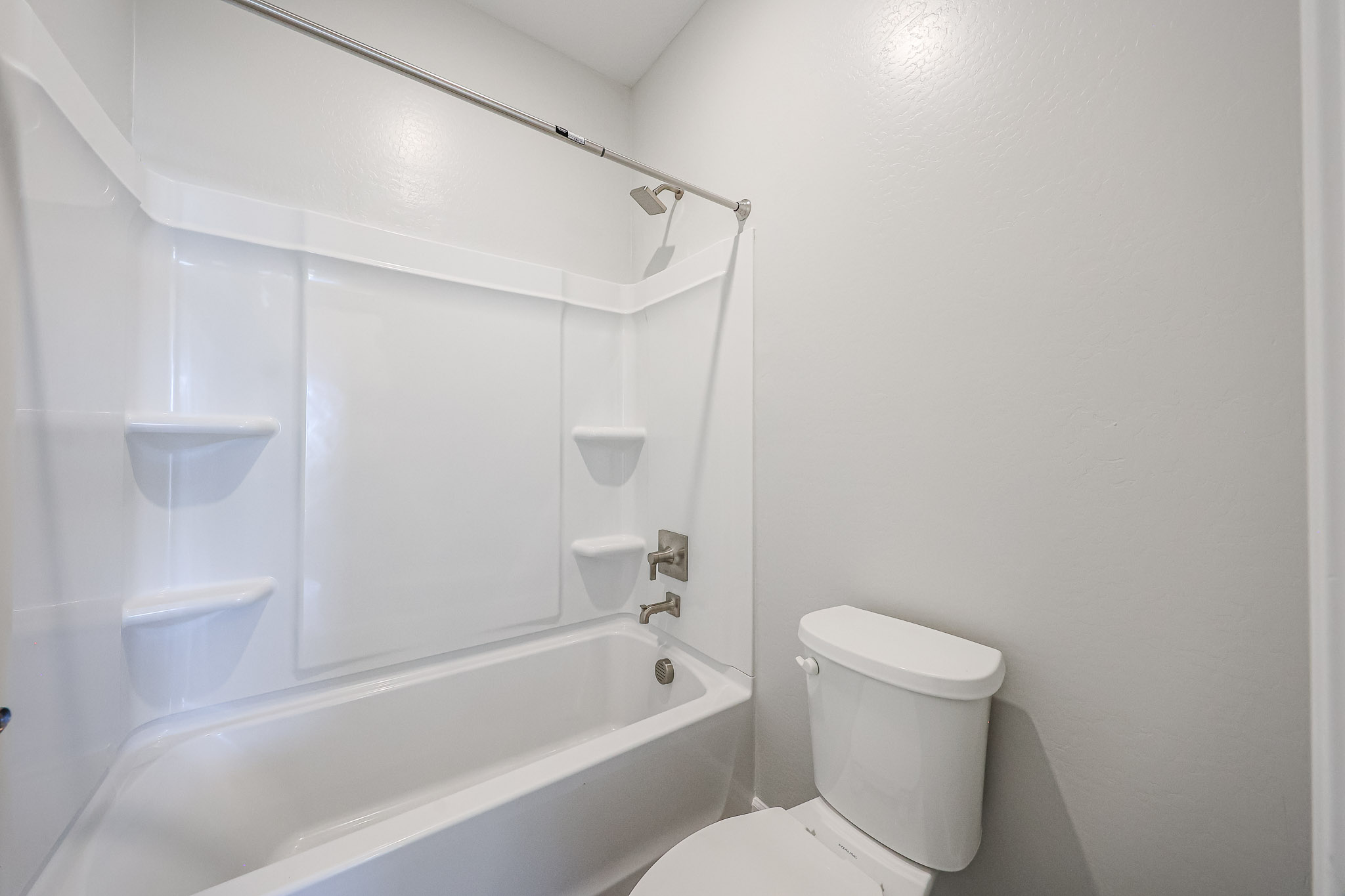 A bathroom with a tub toilet and sink.