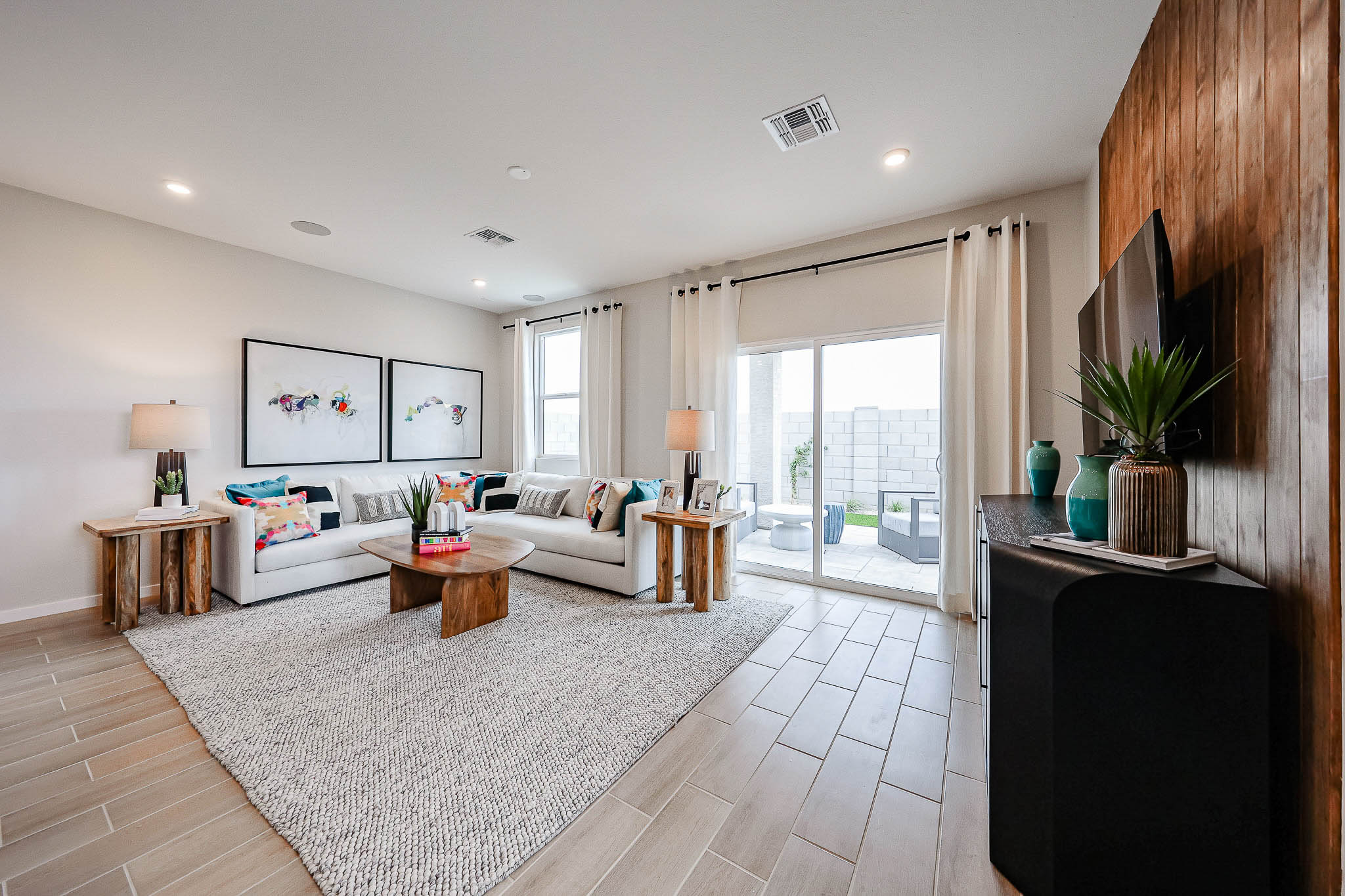 A living room with a large rug.