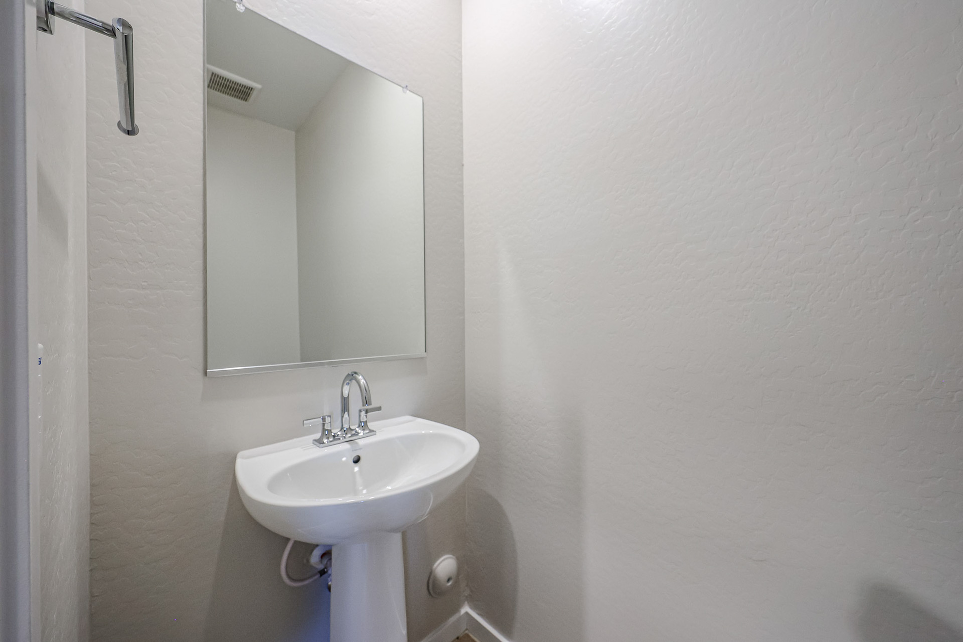 A bathroom with a mirror and sink.