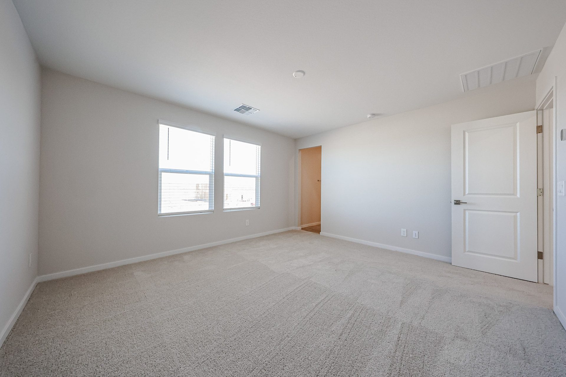 A room with white walls and a window.