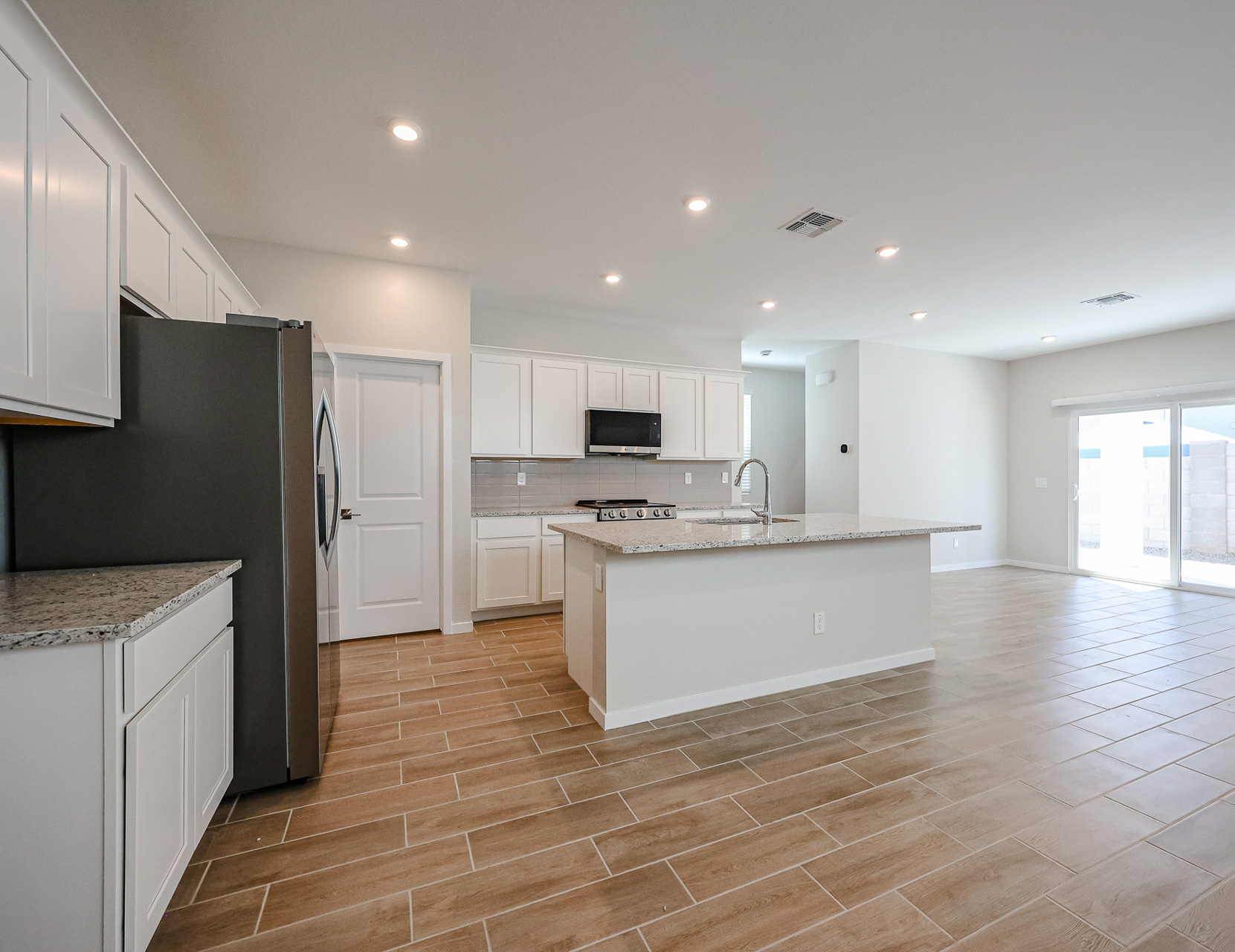 A kitchen with white cabinets.