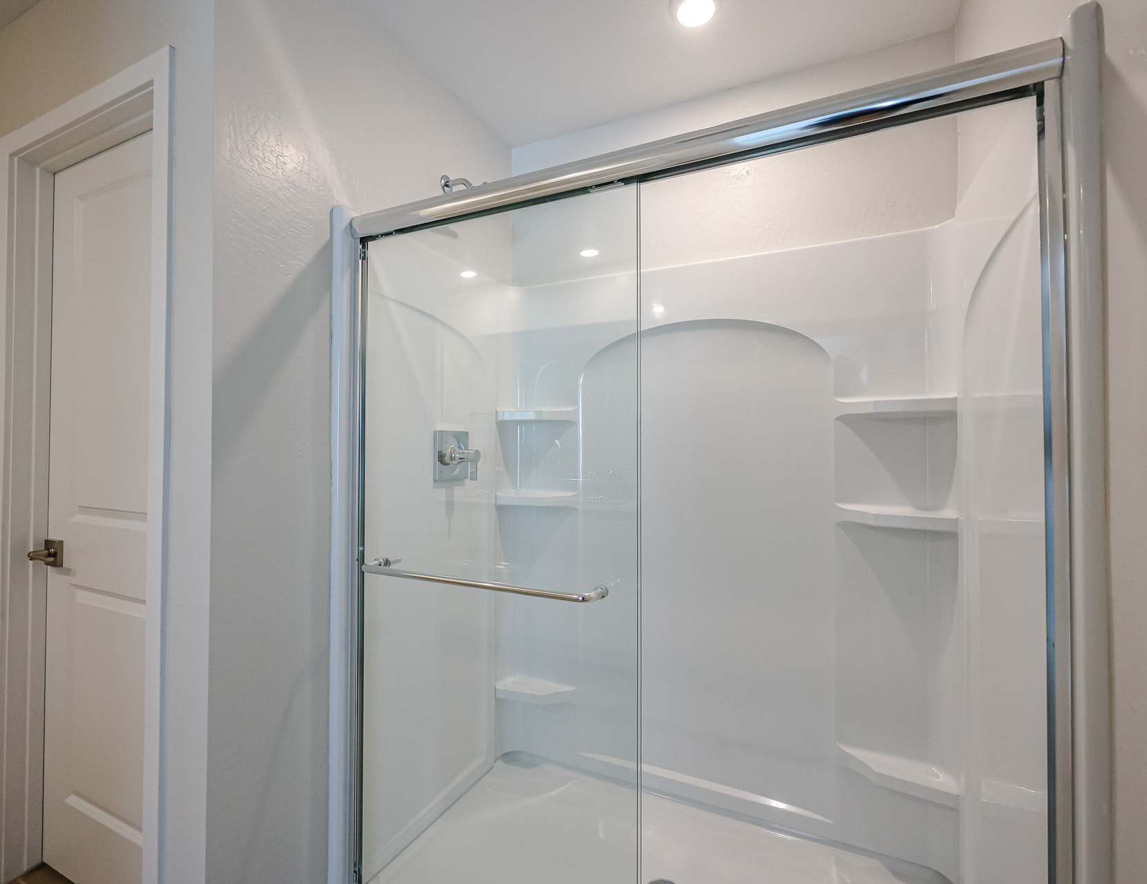 A shower with a glass door.