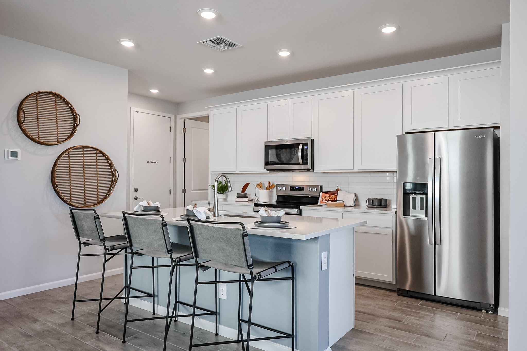 A kitchen with white cabinets.