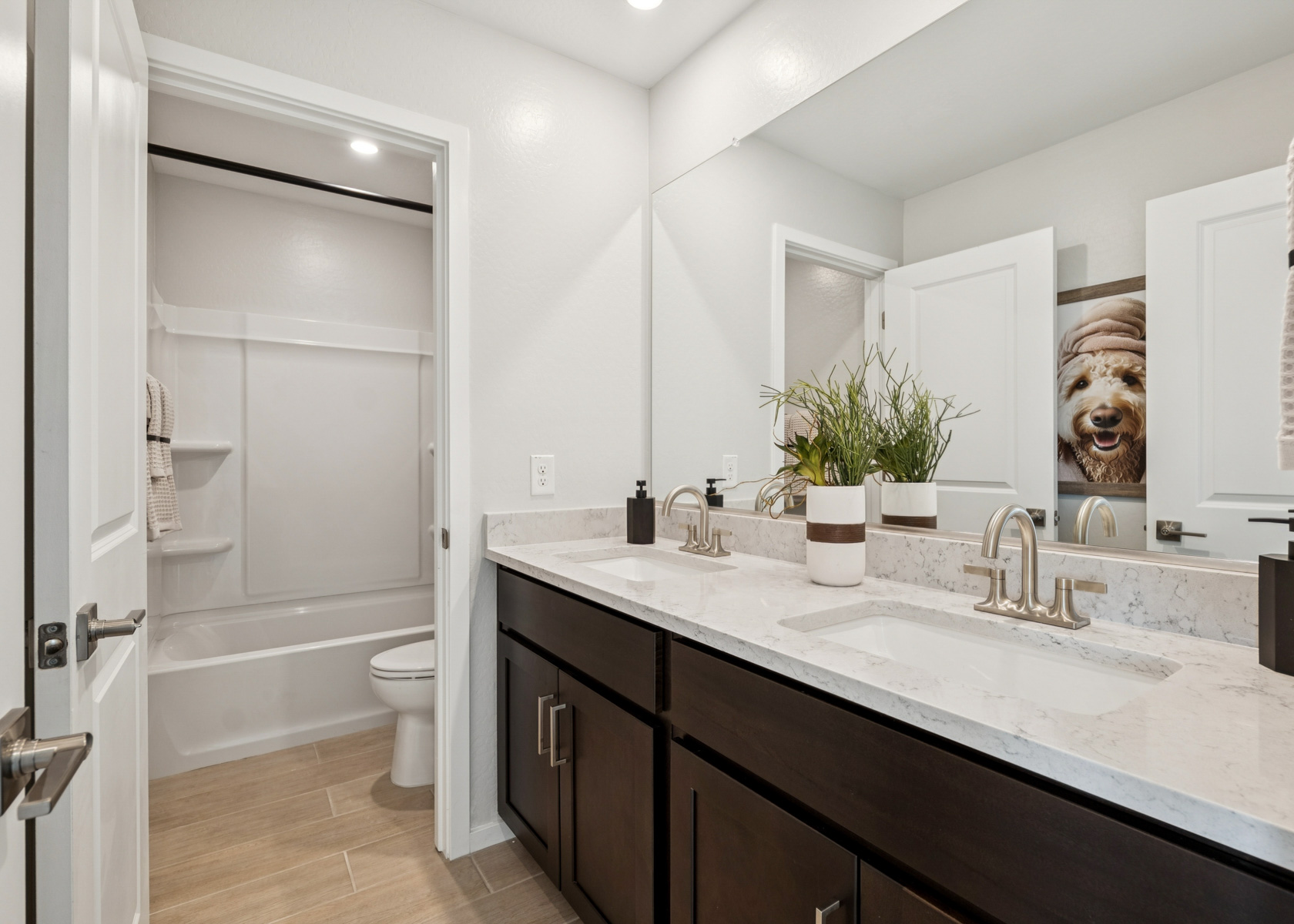 A bathroom with a tub sink and toilet.