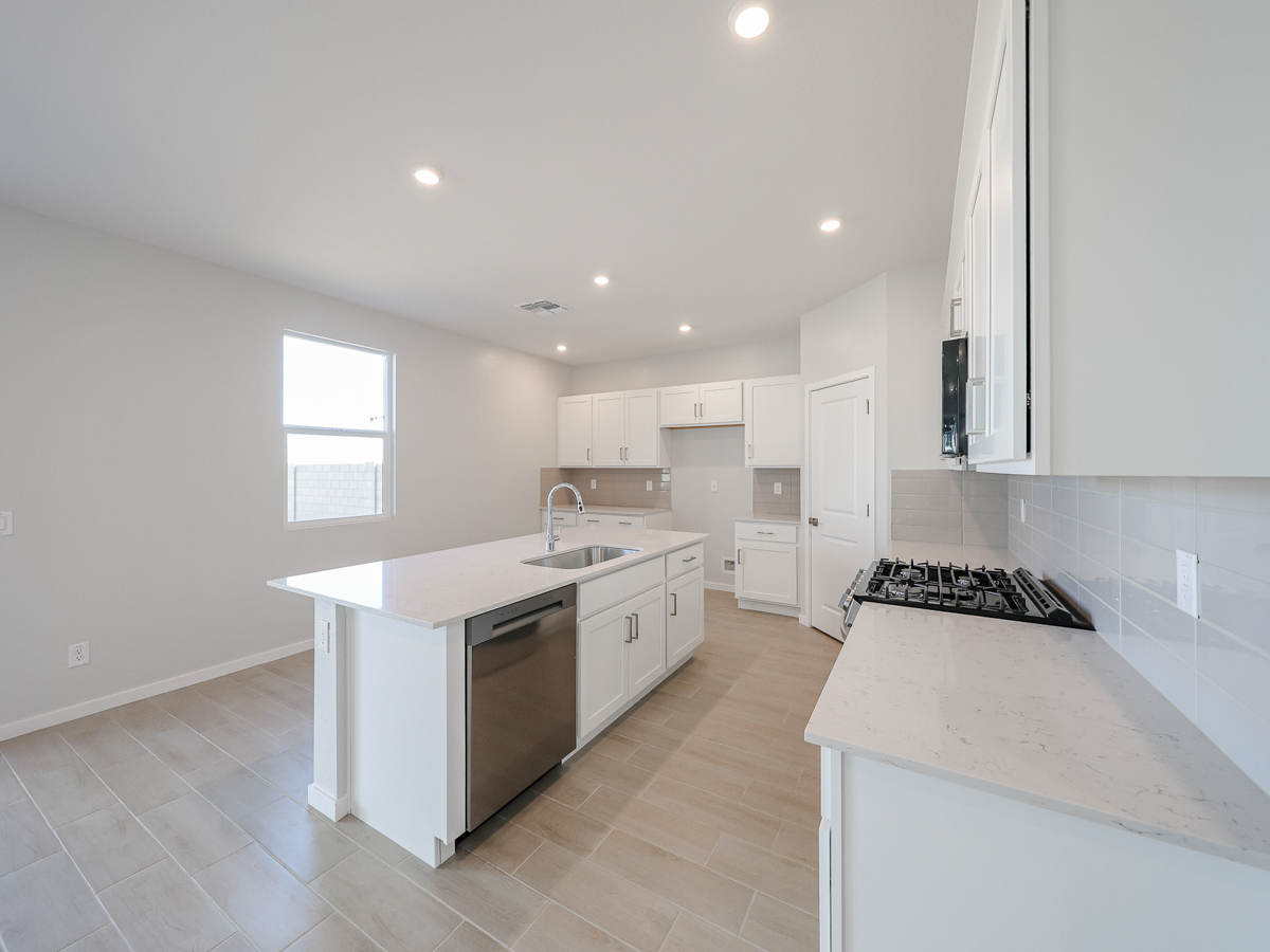 A kitchen with white cabinets.
