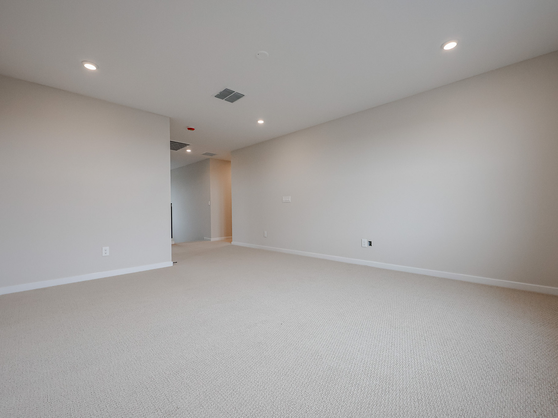 A room with a white wall and a white floor.