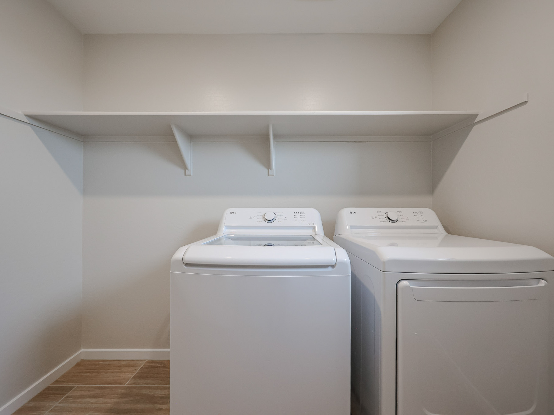 A washing machine and dryer in a room.