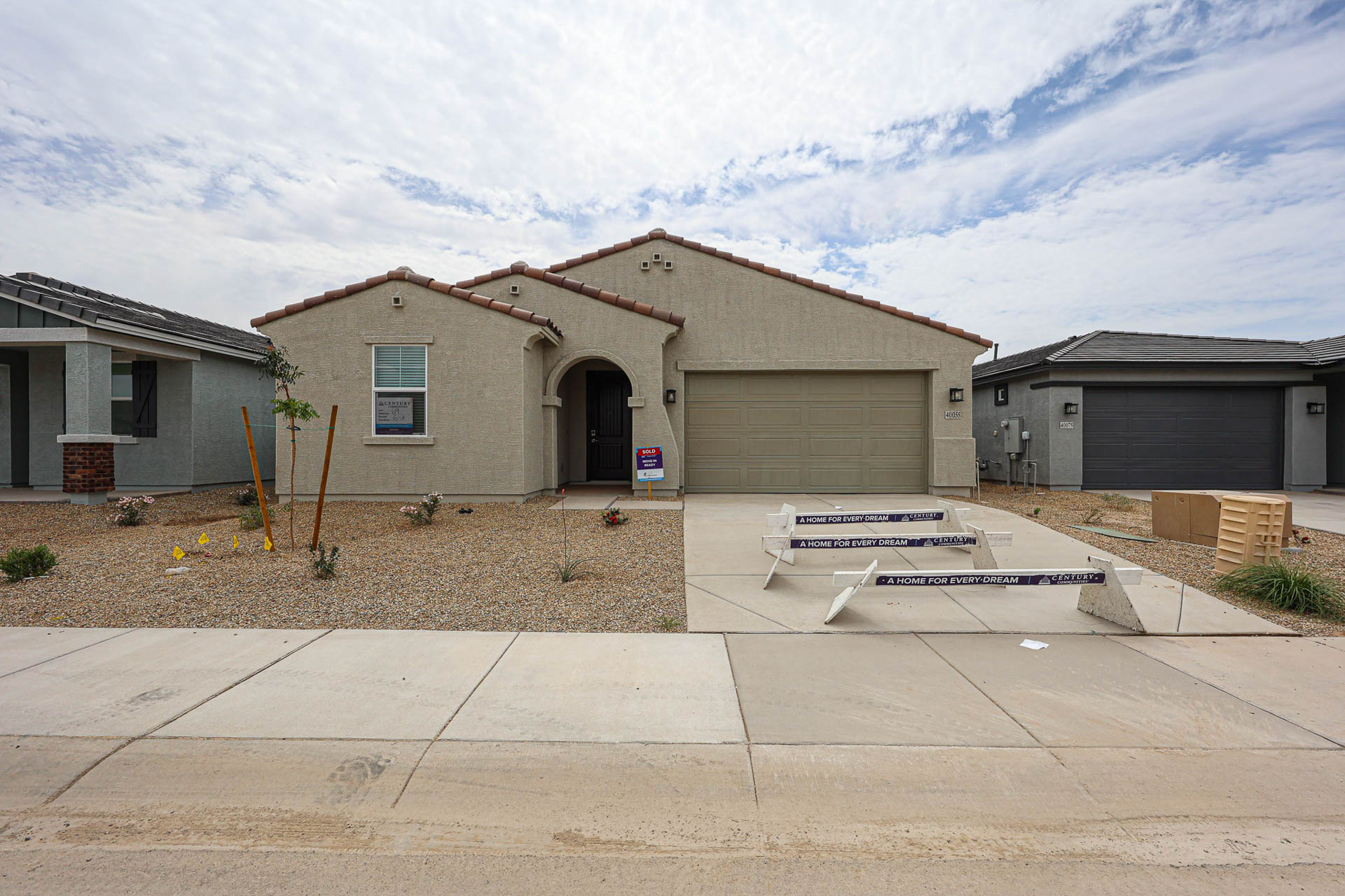 A house with a garage and a boat in the front.