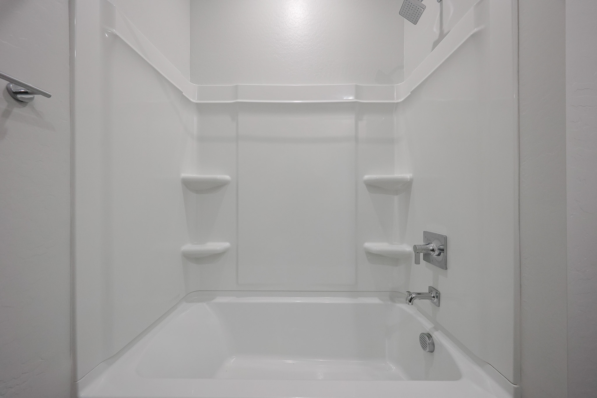 A bathroom with a bathtub and toilet.