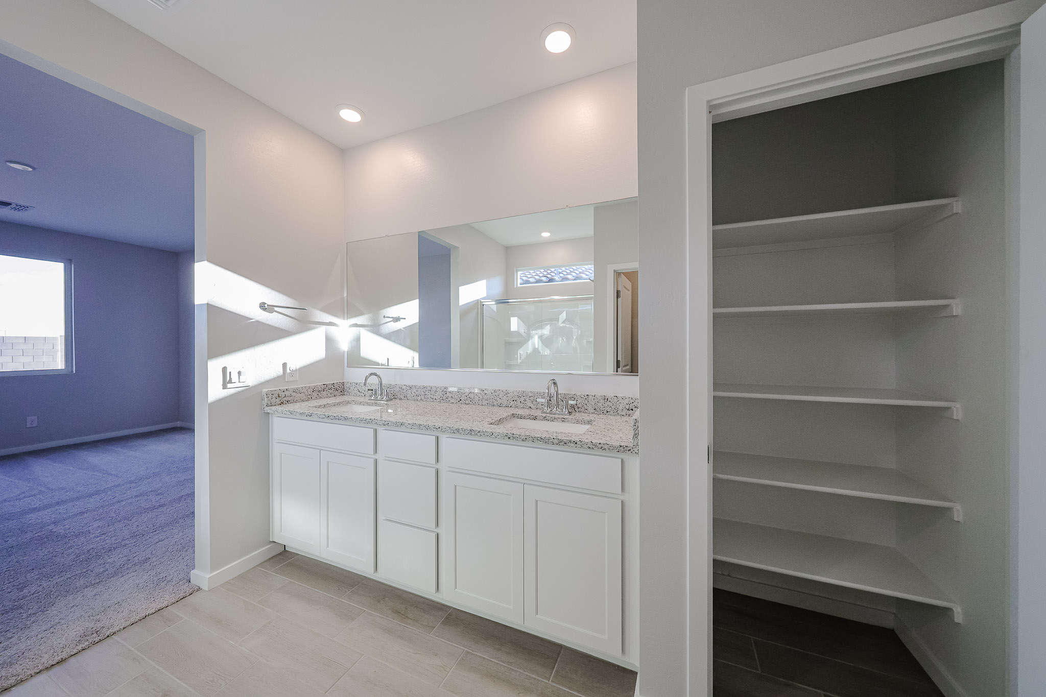 A bathroom with a large mirror.