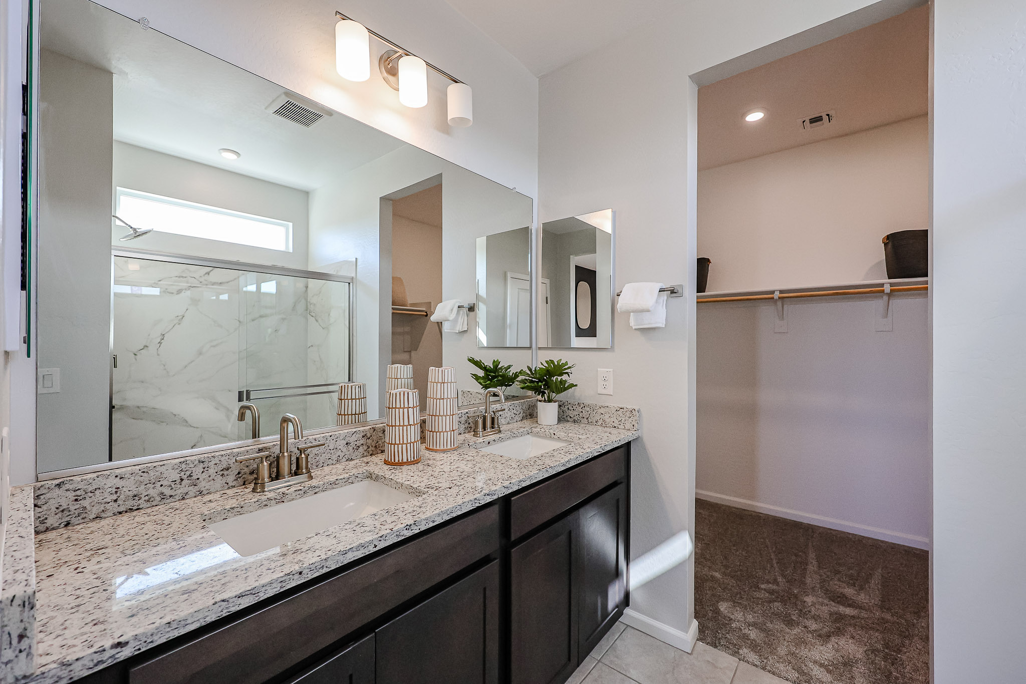 A bathroom with a large mirror.