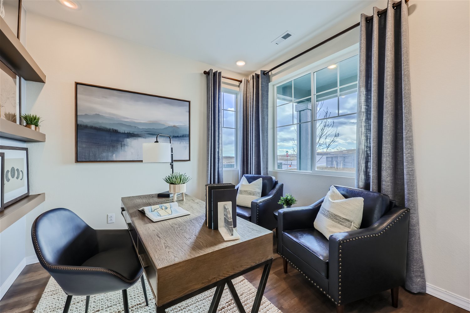 A living room with a table and chairs.