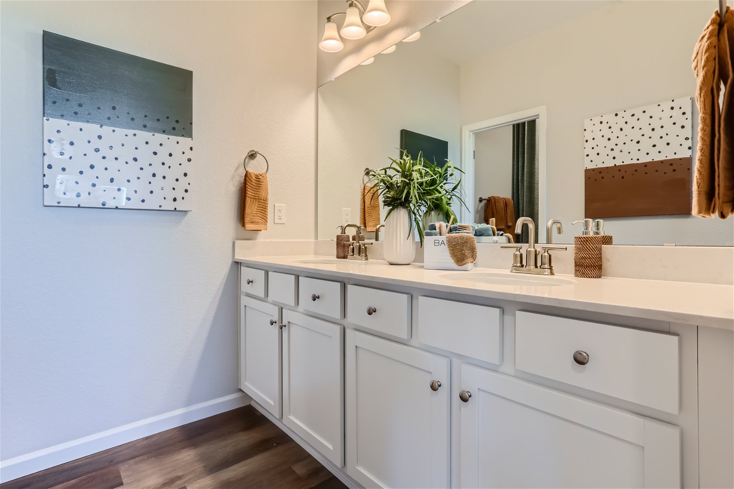 A bathroom with white cabinets.