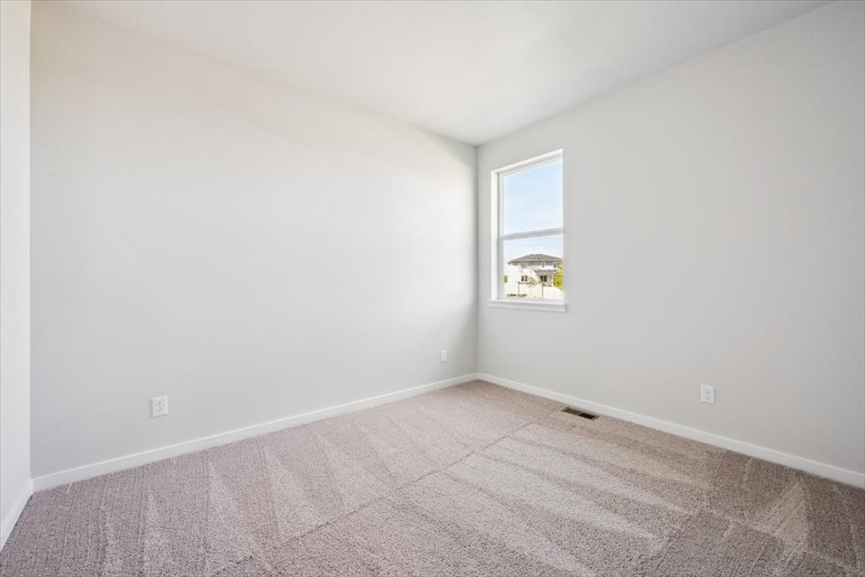 A room with a window and carpet.