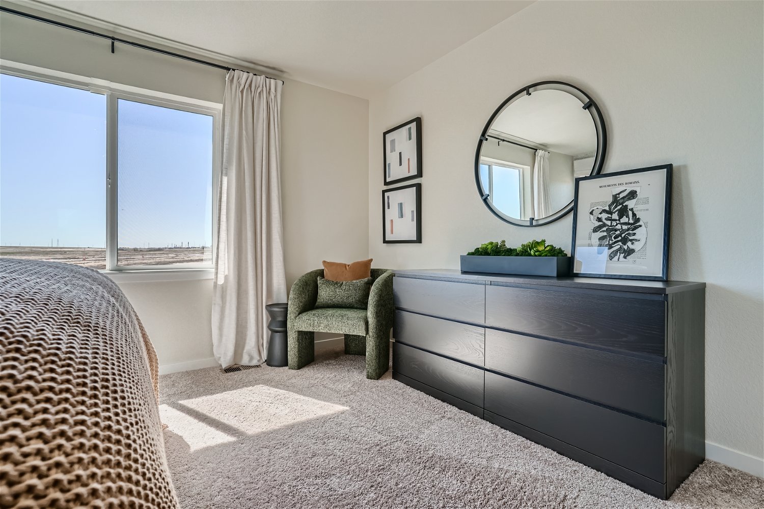 A bedroom with a bed and a mirror.