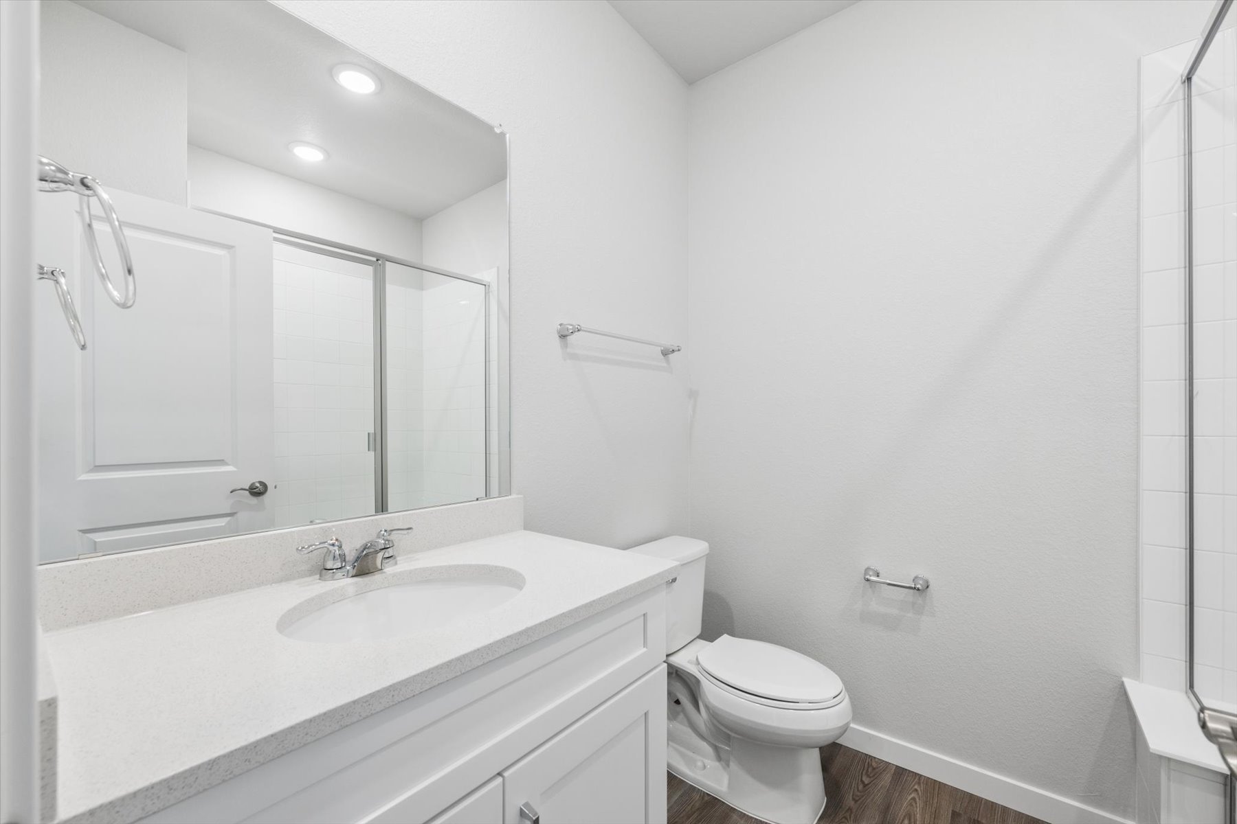 A bathroom with a sink toilet and shower.