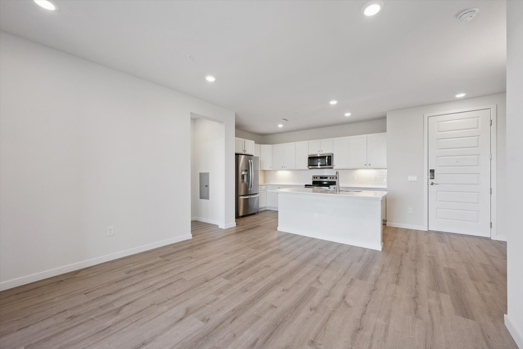A kitchen with white cabinets.