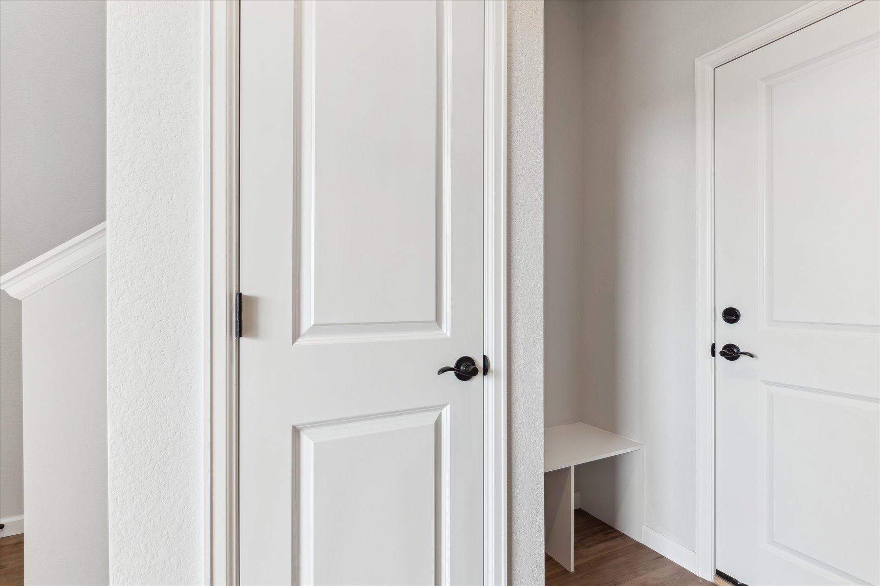 A white door with a chair in the background.