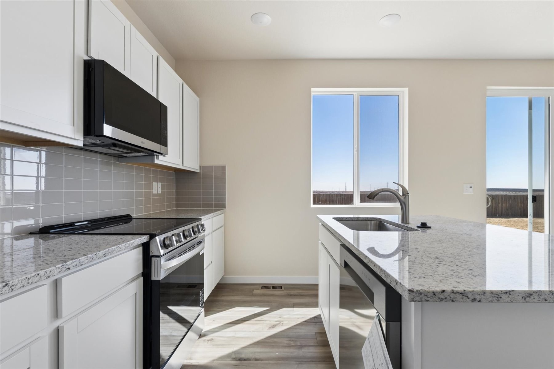 A kitchen with white cabinets.
