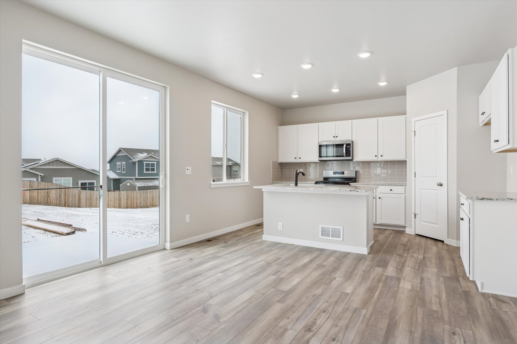 A kitchen with white cabinets.