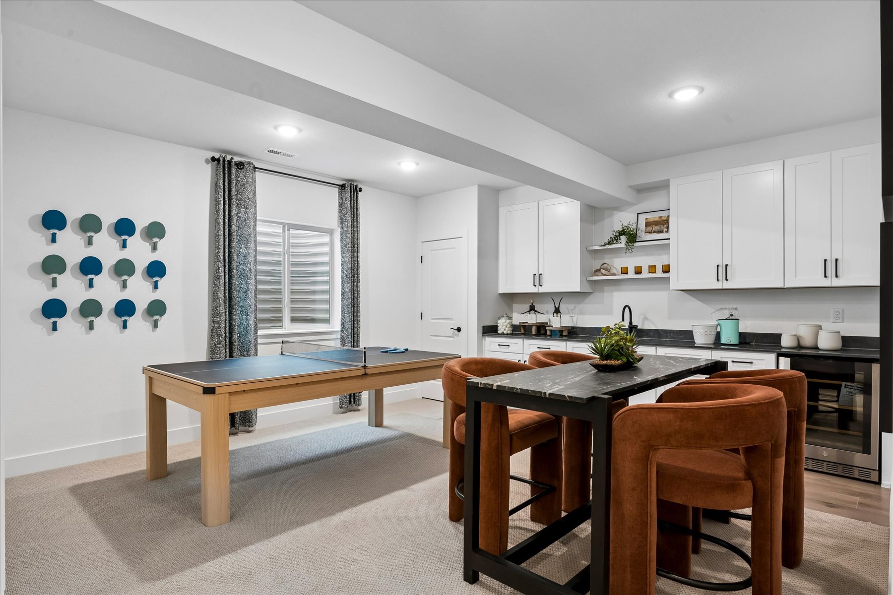 A kitchen with white cabinets.