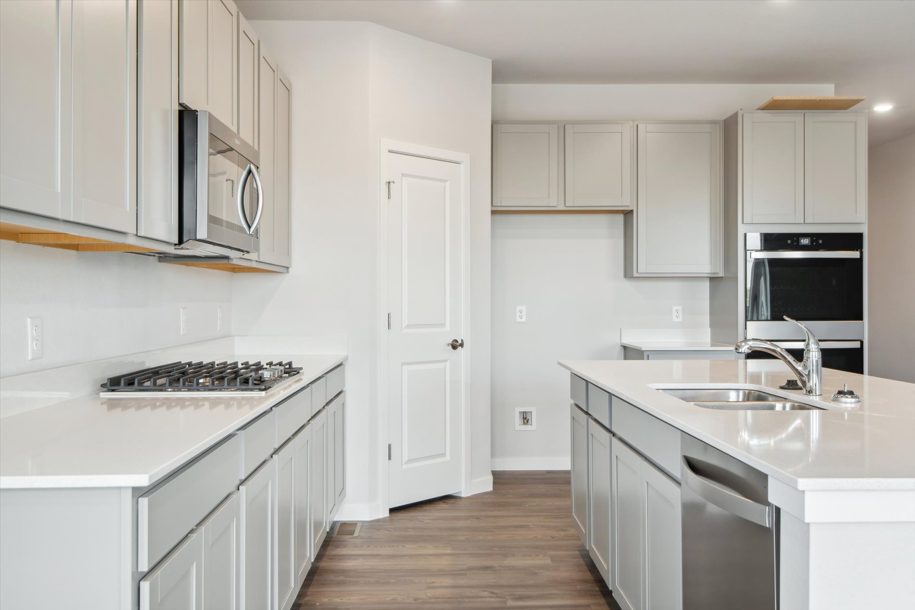 A kitchen with white cabinets.