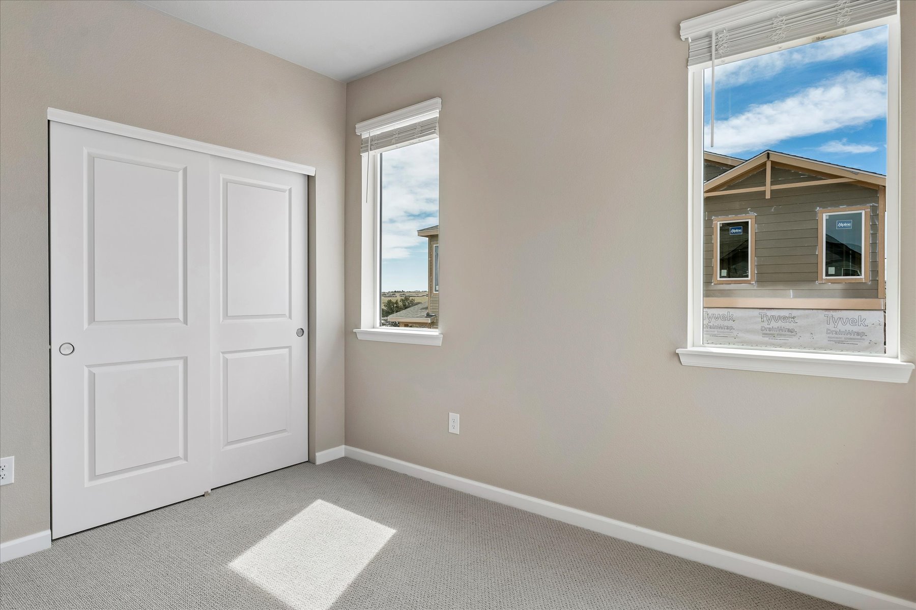 A room with white doors and a window.
