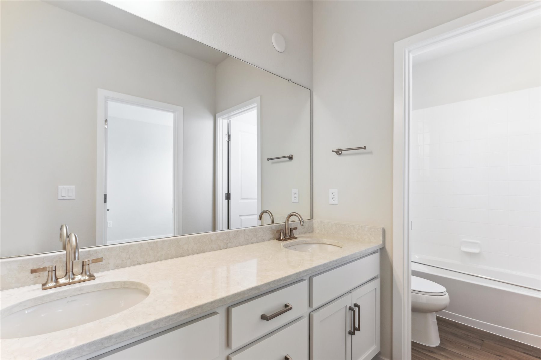 A bathroom with a large mirror.
