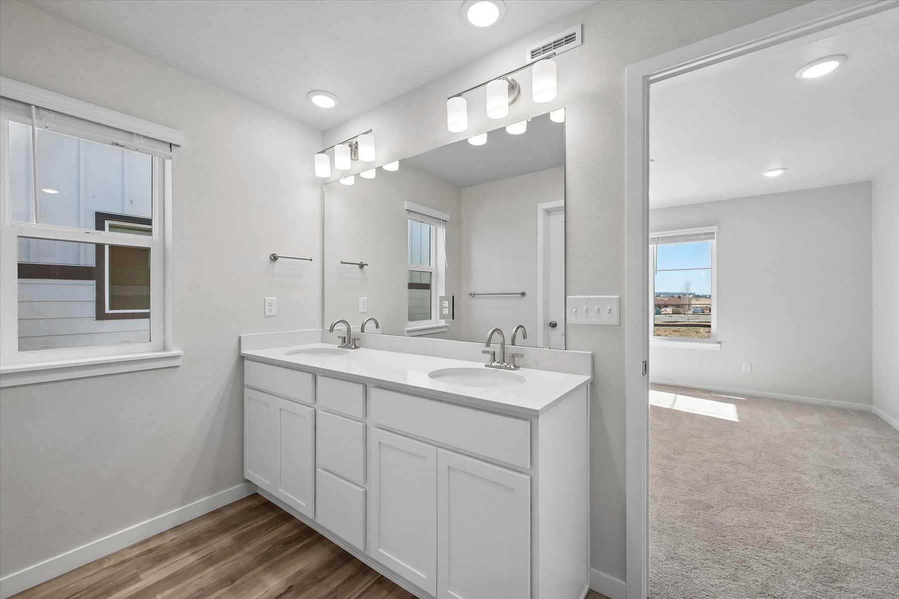 A bathroom with a large mirror.