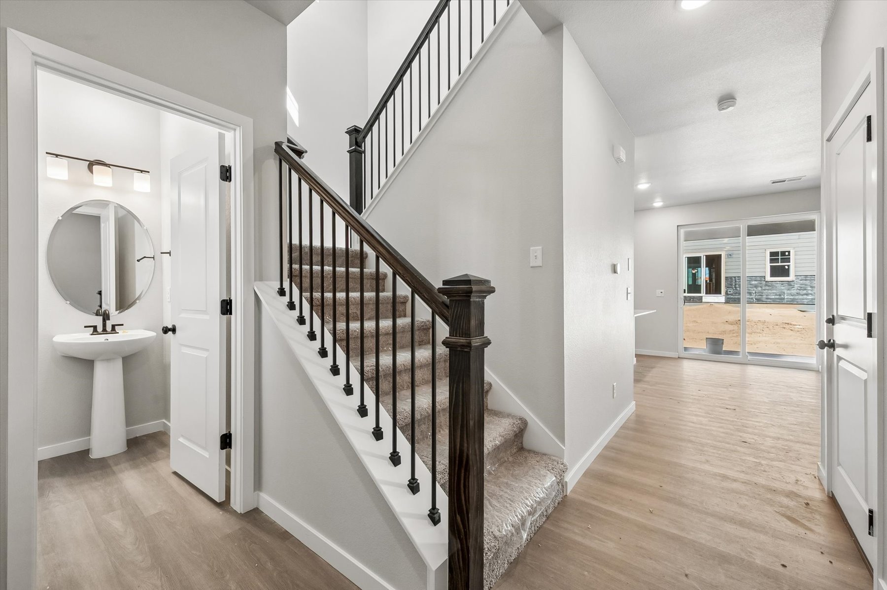 A bathroom with a wood staircase.
