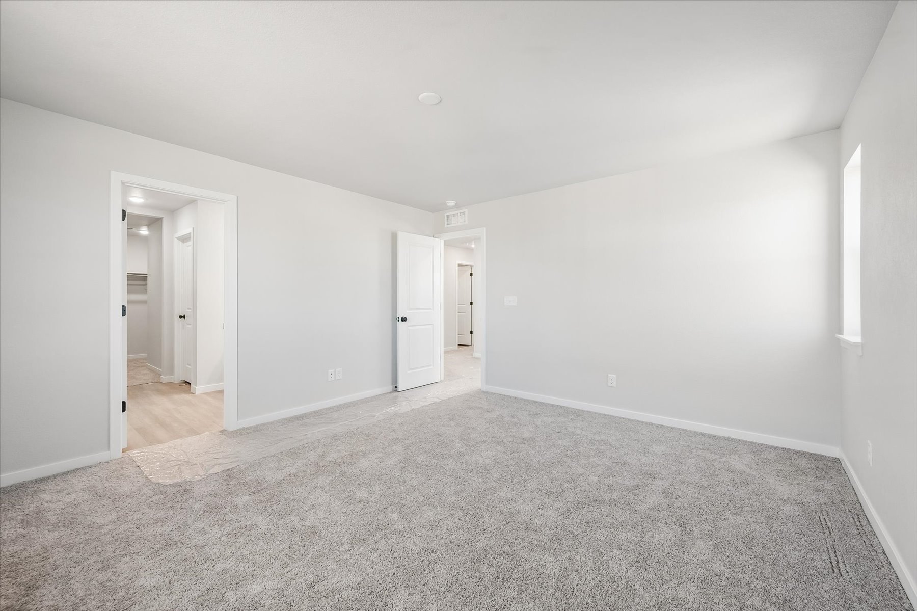 A long hallway with white walls.