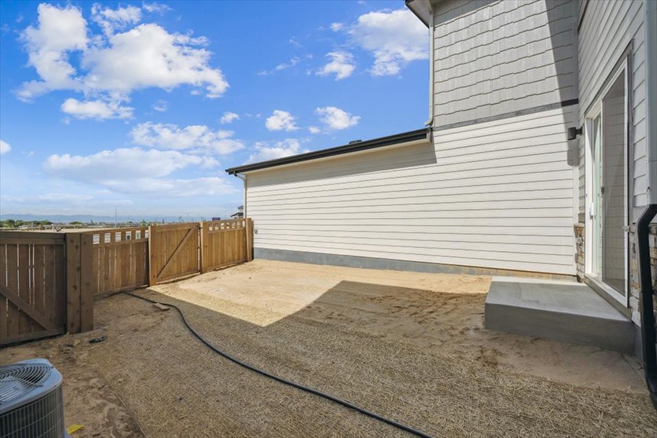 A fenced in area next to a building.