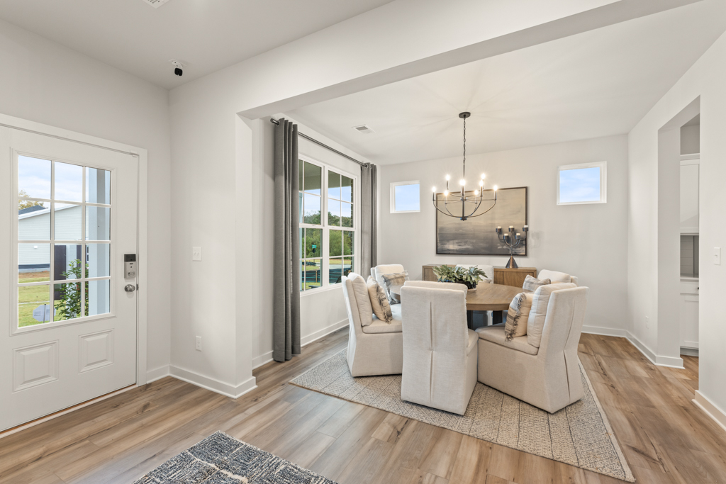 A living room with a white couch and a white rug.