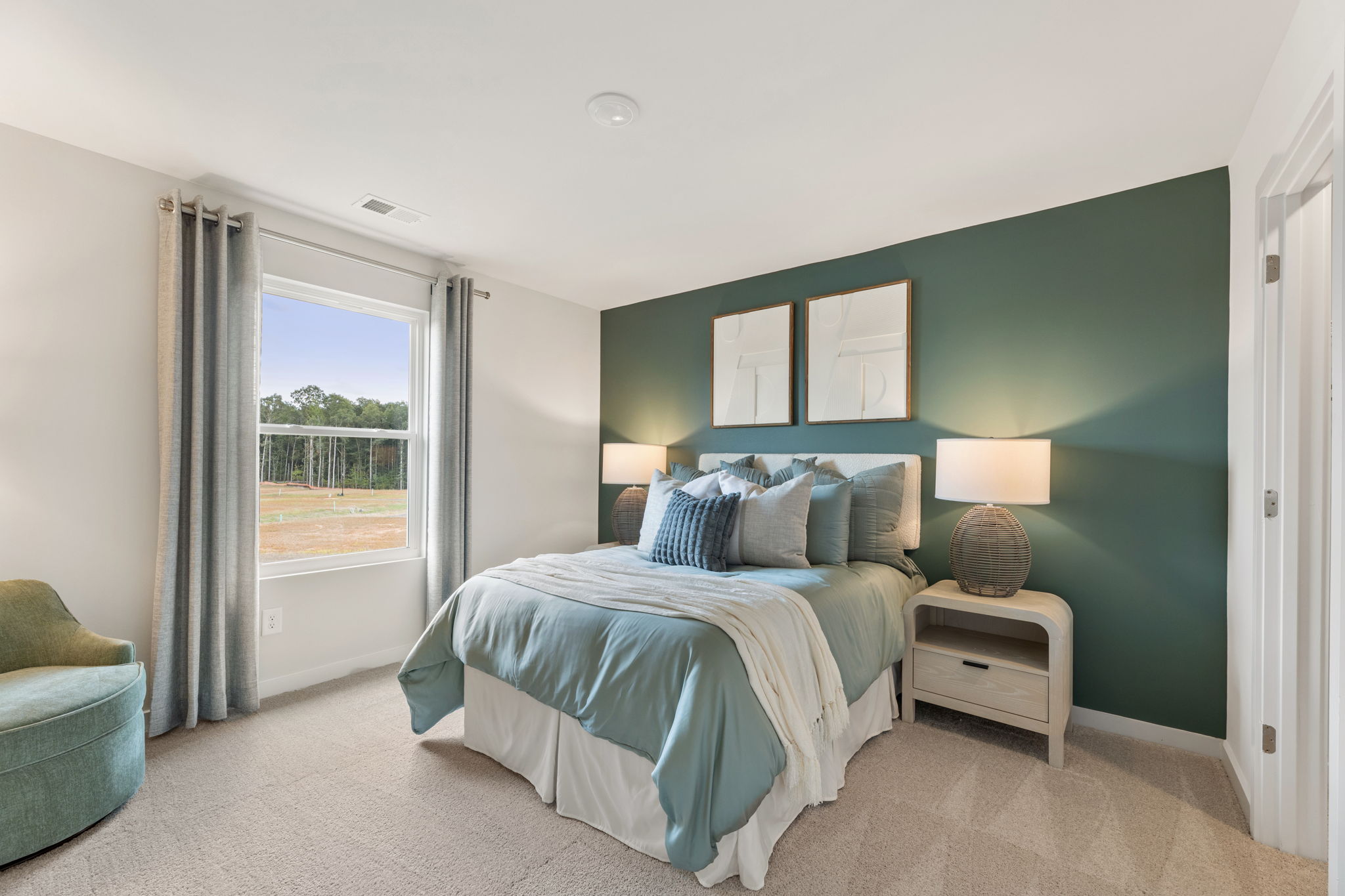 A bedroom with a large window.