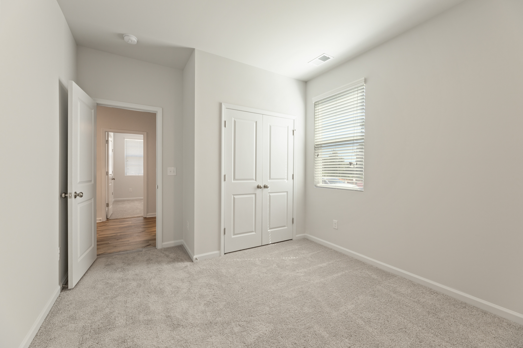 A hallway with white doors.